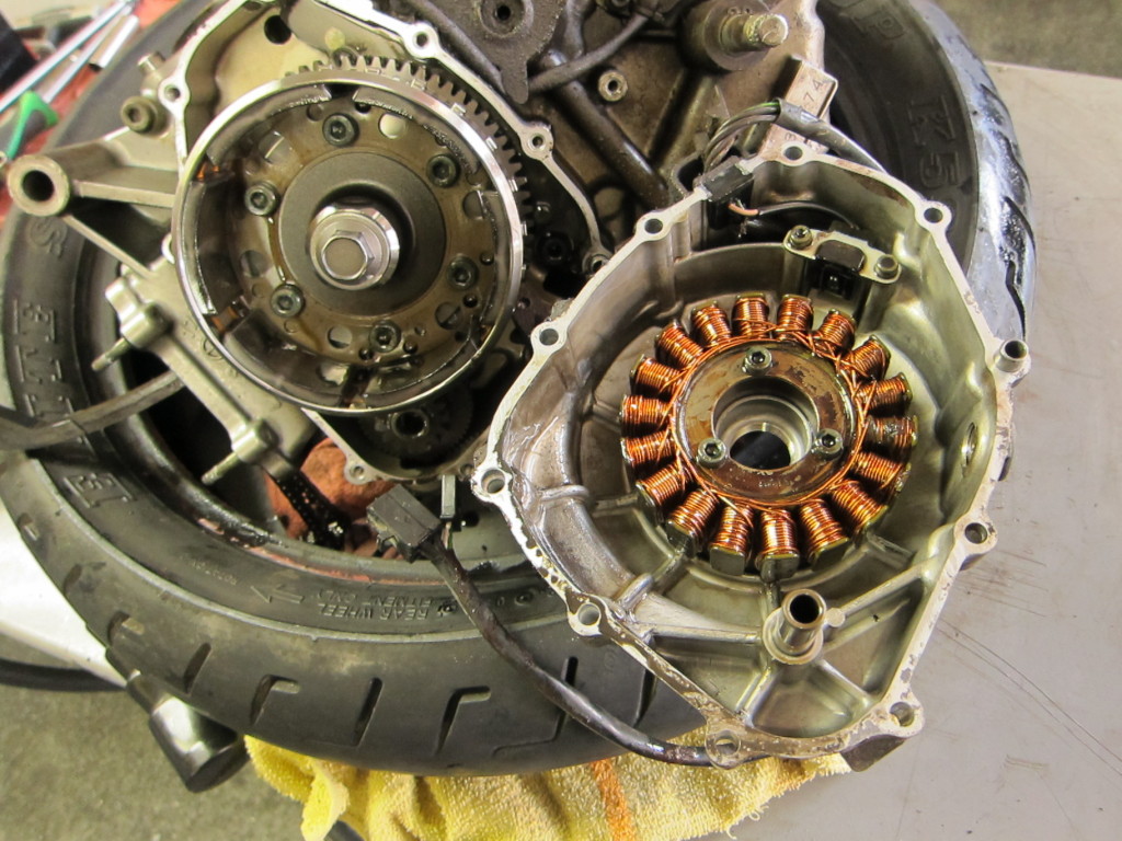 Stator cover, pulled, showing stator coils on right and flywheel on left