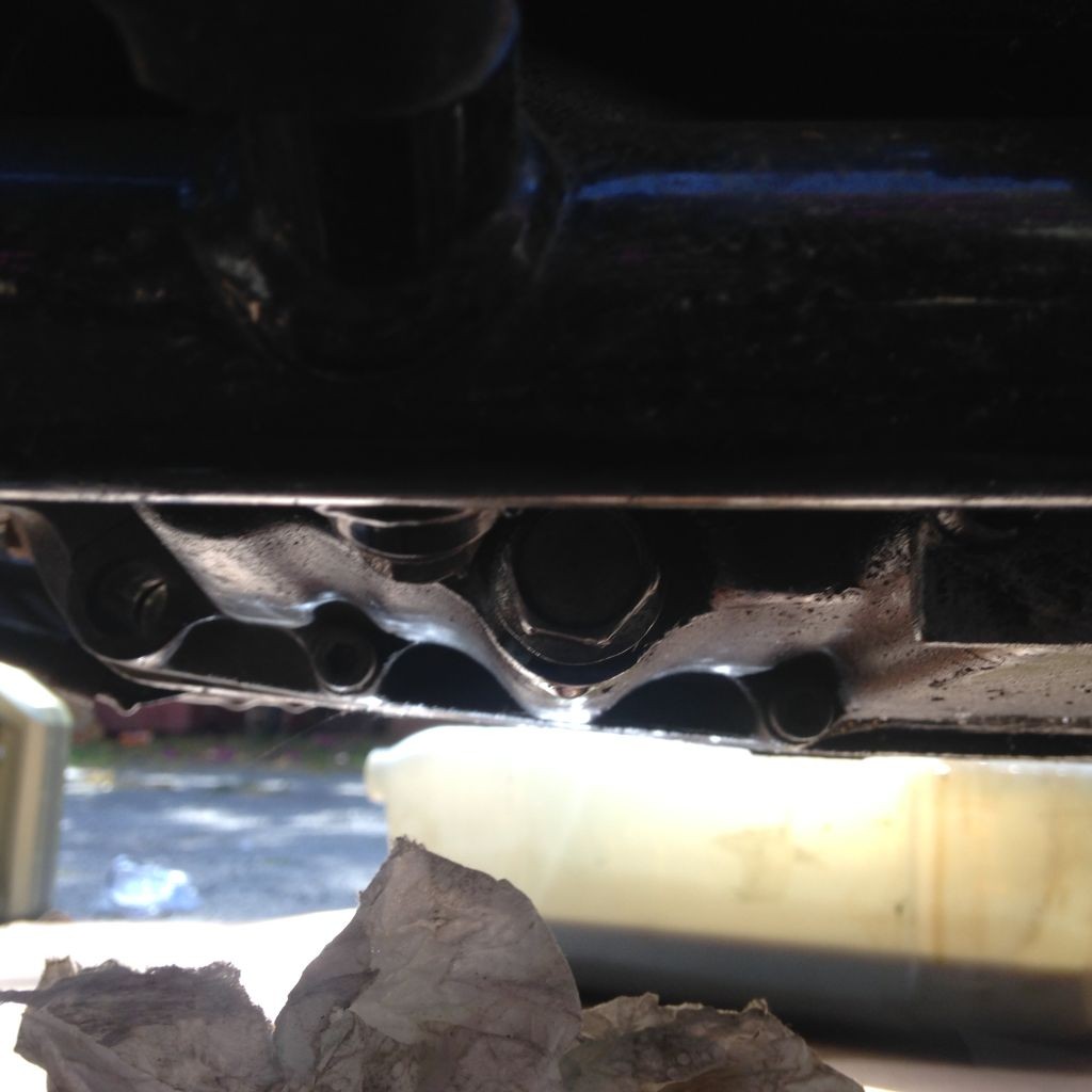 Oil drain bolt on left of oil pan