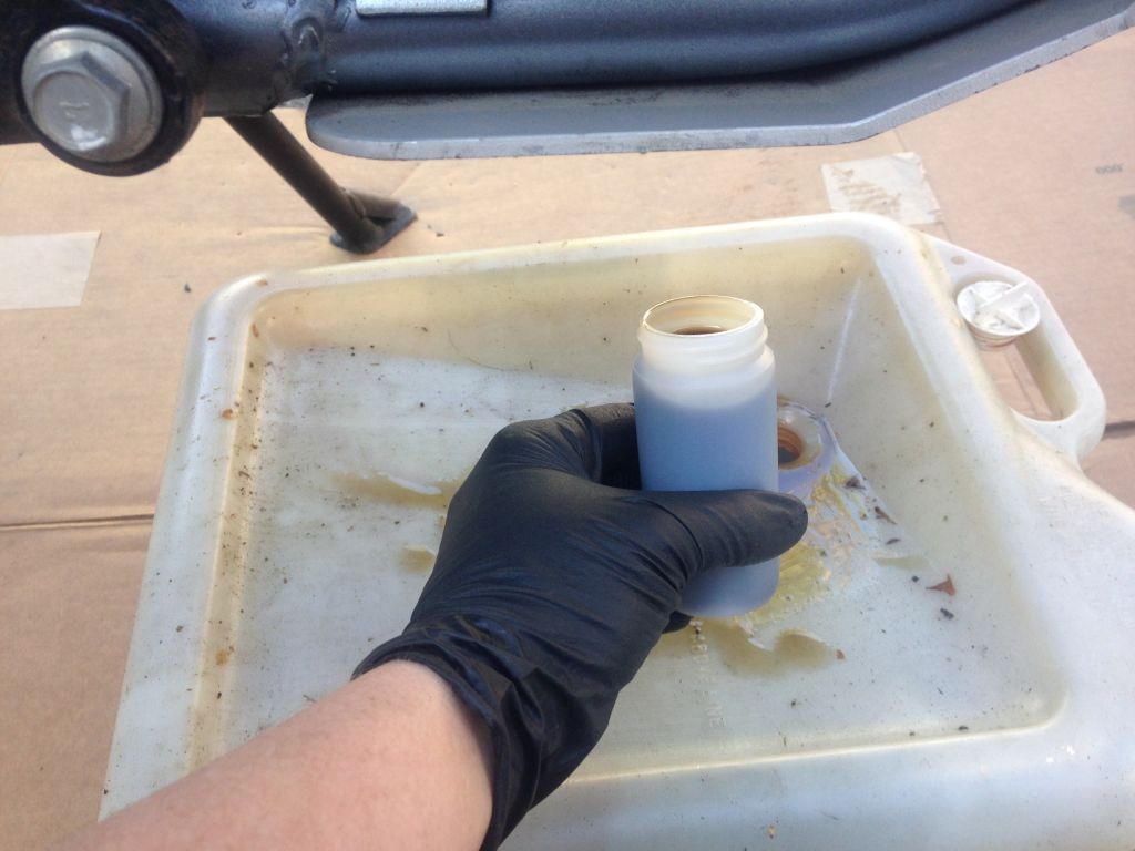 Catching an oil sample in the Blackstone sample bottle